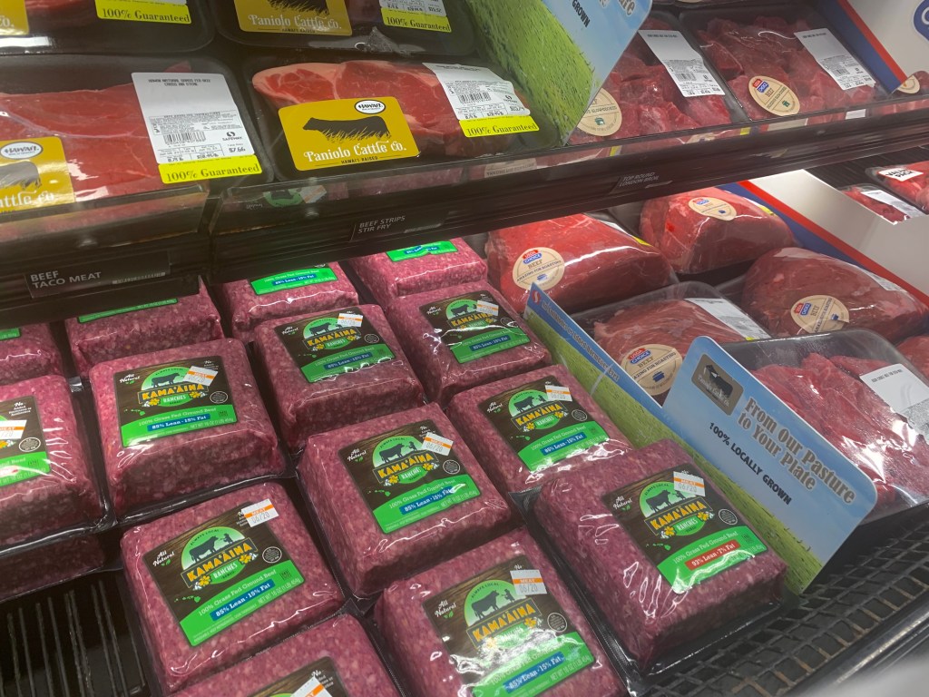 A refrigerator stocked with Paniolo Cattle Company beef, from Parker Ranch, and bricks of ground beef from Idaho billionaire Frank VanderSloot's Kamaaina brand.