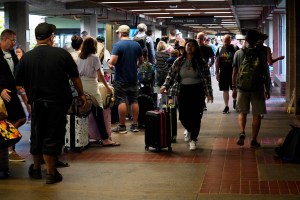 The line to get through TSA at Kahului Airport Wednesday, Aug. 9, 2023, in Kahului. The line stretched from the security entrance to baggage claim. A large fire consumed the popular town of Lahaina overnight. (Kevin Fujii/Civil Beat/2023)