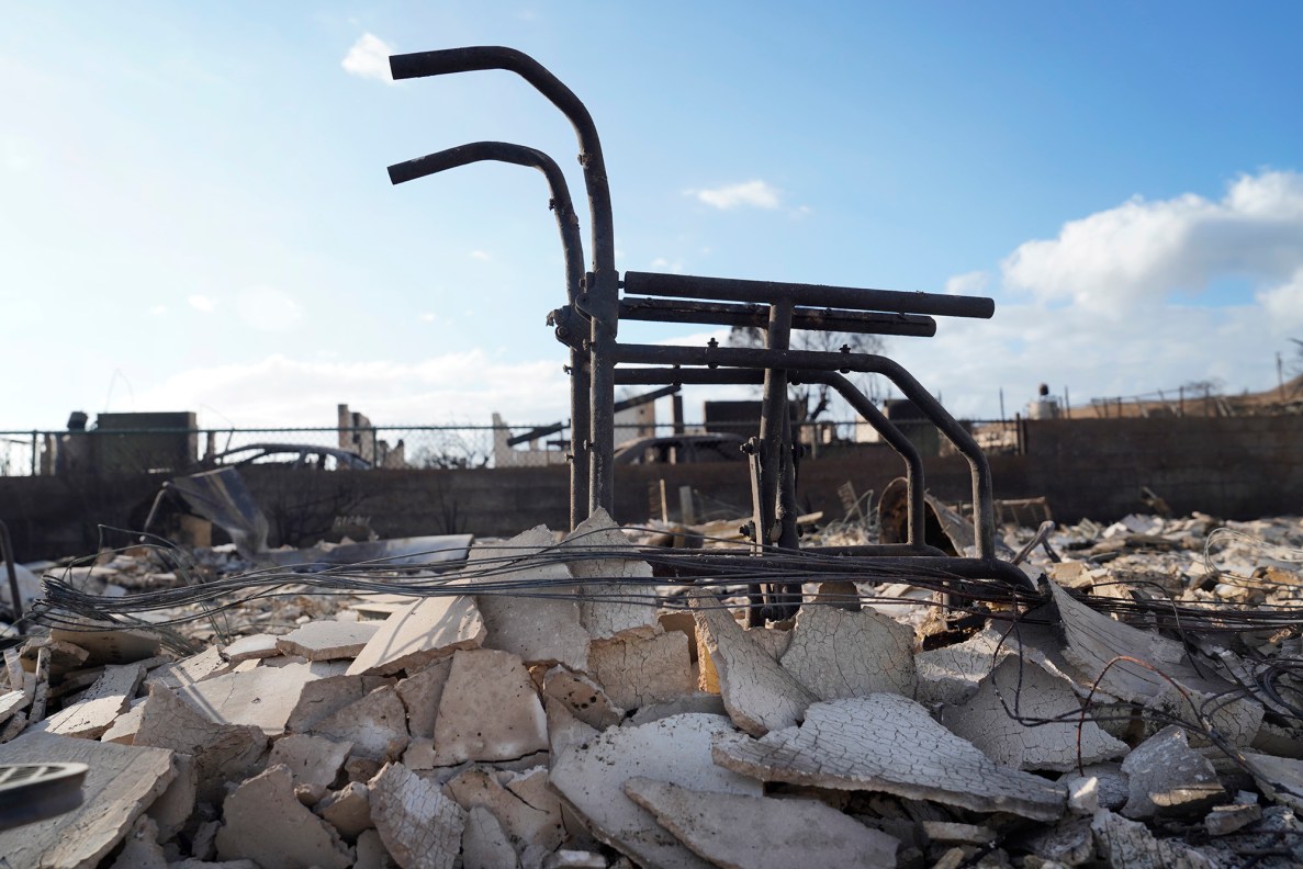 A wheelchair remains at the Hale Mahaolu Eono grounds Thursday, Aug. 10, 2023, in Lahaina. The kapuna residence was destroyed in a fast moving wildfire Tuesday night.  (Kevin Fujii/Civil Beat/2023)