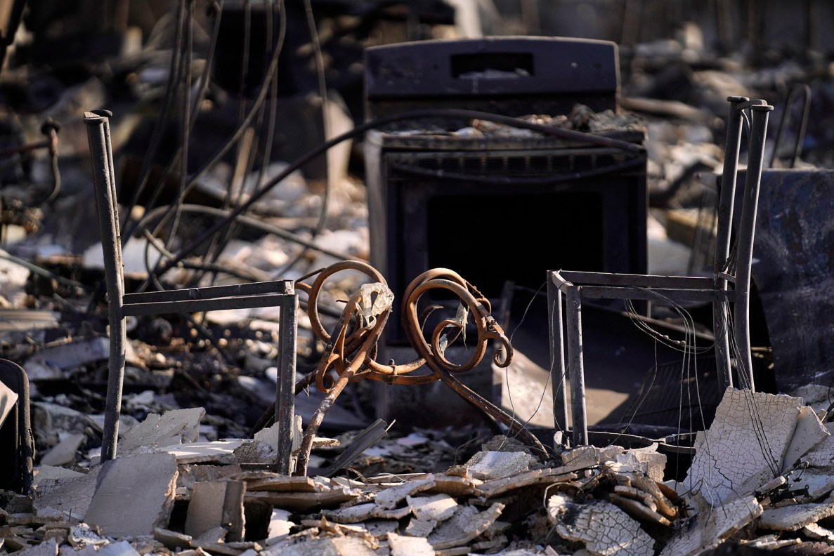 The frame of chairs and a table remain in Hale Mahaolu Eono Thursday, Aug. 10, 2023, in Lahaina. The kapuna resident home was destroyed in Tuesday night’s wildfire. (Kevin Fujii/Civil Beat/2023)