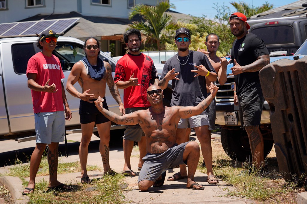 Despite the tragedy, residents gather together to help the neighborhood and pose for a photo Sunday, Aug. 13, 2023, north of Lahaina town and south of Kaanapali. A large fire consumed areas of West Maui last week. Utilities have not been fully restored.  (Kevin Fujii/Civil Beat/2023)