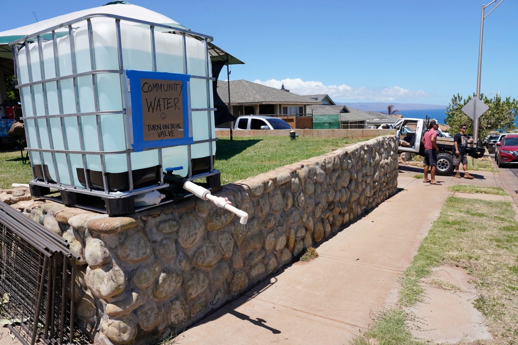 Supplies to help those affected by the wildfires are distributed Sunday, Aug. 13, 2023, in Napili. A large fire consumed areas of West Maui last week. Utilities have not been fully restored.  (Kevin Fujii/Civil Beat/2023)