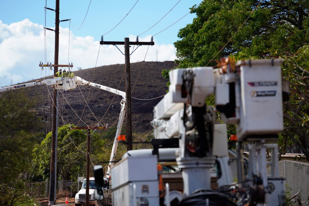 HECO crews work on utility lines mauka of the Lahaina Bypass Sunday, Aug. 13, 2023, in Lahaina. A large fire consumed areas of West Maui last week. Utilities have not been fully restored. (Kevin Fujii/Civil Beat/2023)