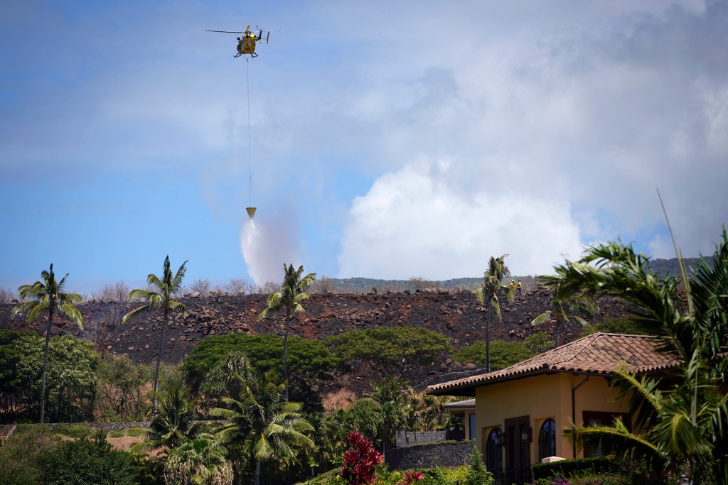 Maui Fire Department works on extinguishing a brushfire north of Lahaina Saturday, Aug. 26, 2023. An evacuation order was sent out to mobile phones and warning sirens blared in West Maui near Anapuni Loop to West Mahipulu. (Kevin Fujii/Civil Beat/2023)