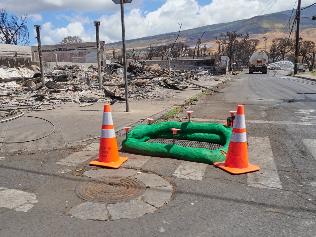 A barricade is placed around a drain in Lahaina, Maui
