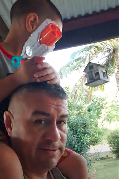 Carlos Valdez gives his son a shoulder ride