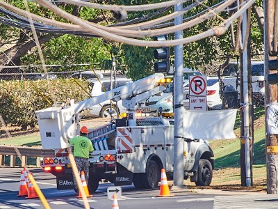 Alineman and his truck occupy most of the image as he prepares to fix problems