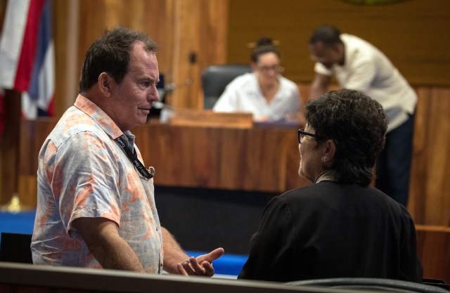 Maui County Council member Tom Cook talks with Council Chair Alice Lee after a committee meeting Monday. (Nathan Eagle/Civil Beat/2023)