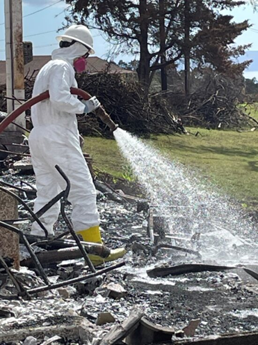 An EPA hazardous waste removal team sprays Soiltac on burned property in Kula in September 2023. (Courtesy: EPA)