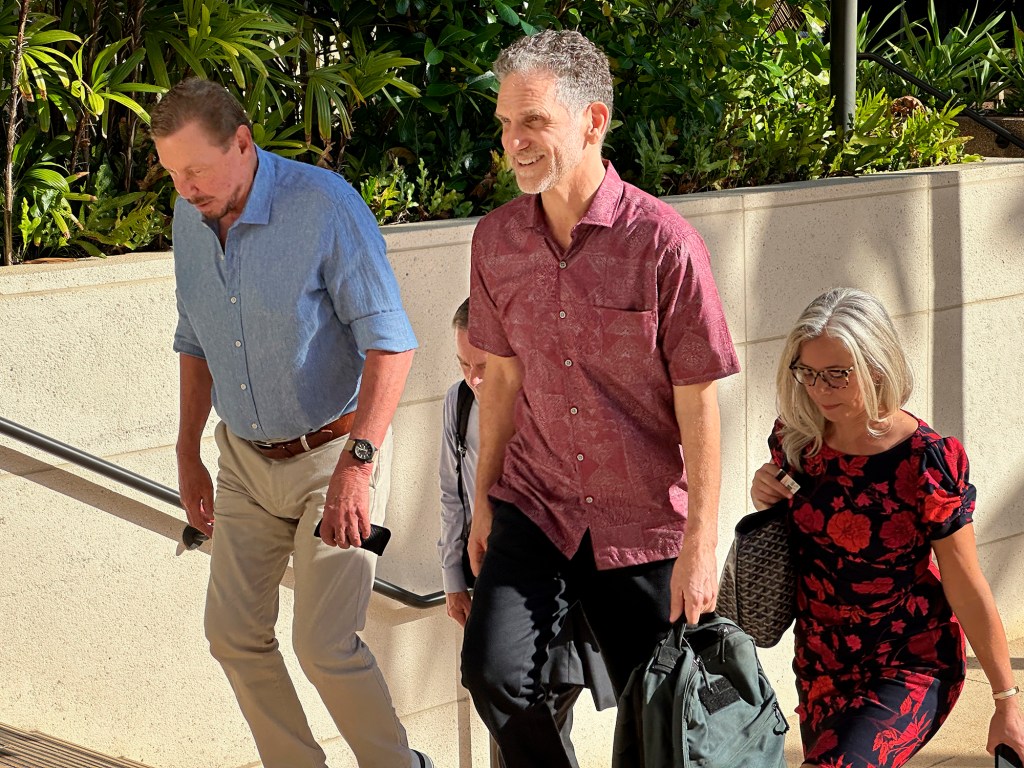 Larry Ellison, from left, and Paul Marinelli, former director of Island Air, enter the Prince Kuhio Federal Building Wednesday, Oct. 4, 2023, in Honolulu. Ellison is testifying in federal court in the Island Air bankruptcy case. (Kevin Fujii/Civil Beat/2023)