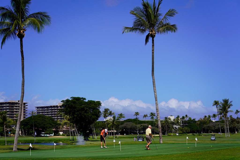 Golfers practice on the Royal Ka’anapali Golf Course practice green Thursday, Nov. 9, 2023, in Lahaina. The area north of Lahaina town escaped damage from the Aug. 8. fire. Tourism reopened in West Maui on Nov. 1. (Kevin Fujii/Civil Beat/2023)