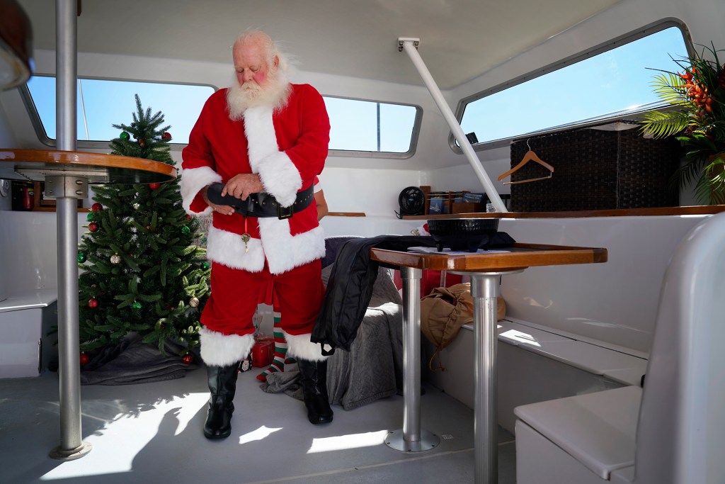 Ron Proctor dresses for his duties as Santa Claus in what has become a very special year. Proctor has played Santa for more than 25 years but he lost his Lahaina home and belongings, including the hand-made Santa suit his daughter made, in the Aug. 8 fire. (Kevin Fujii/Civil Beat/2023)