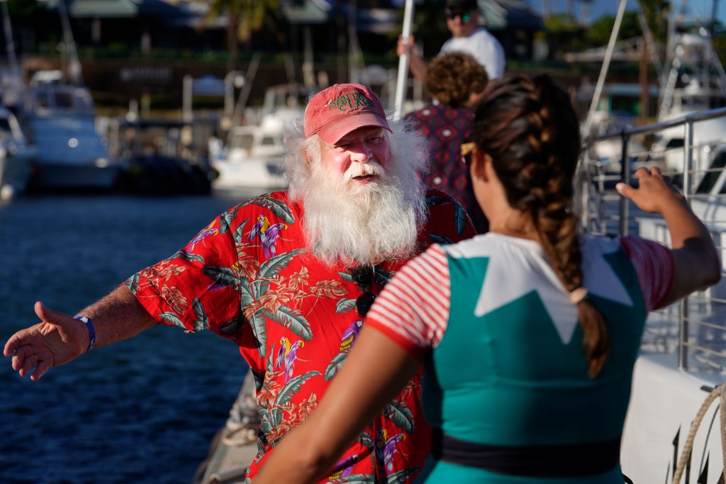 Proctor hugs Alii Nui crew member Chloe Marino after their Sunset Sail Sail Cruise. (Kevin Fujii/Civil Beat/2023)