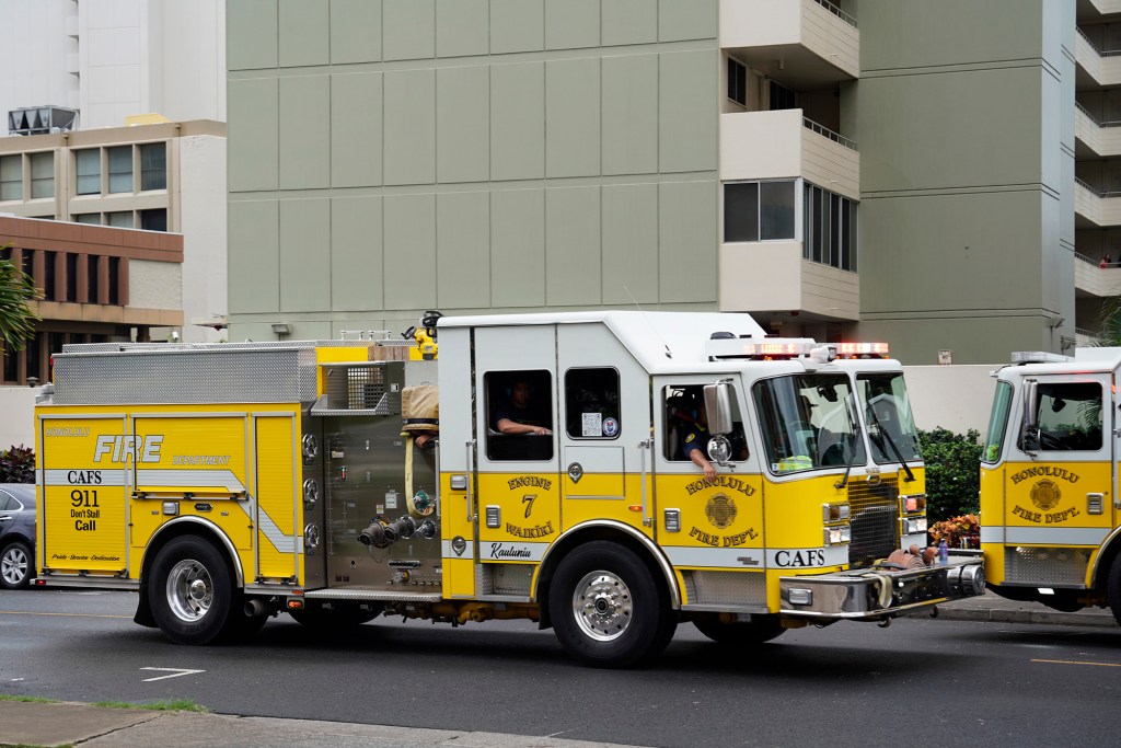 Honolulu Fire Department Engine 7 Waikiki leaves after extinguishing the Wood Rose Apartment fire at 780 Amana St. Thursday, Nov. 30, 2023, in Honolulu. (Kevin Fujii/Civil Beat/2023)