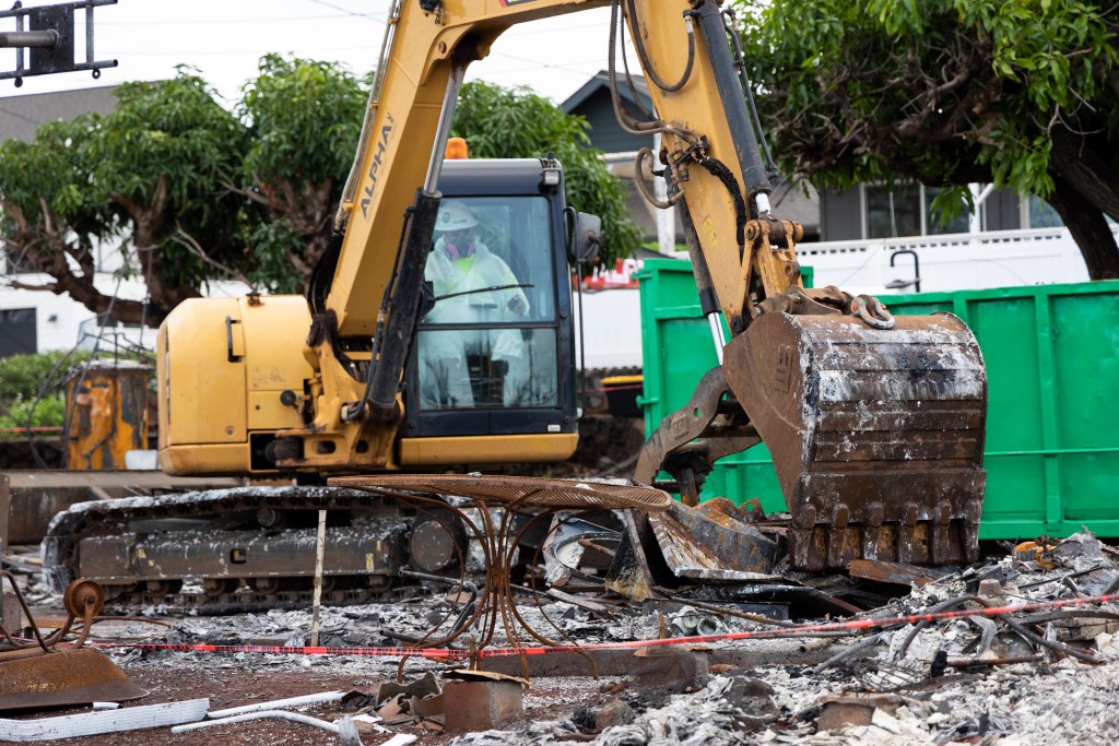 Alpha Inc. earthmover doing debris removal at site in Lahaina in Janaruary 2024.