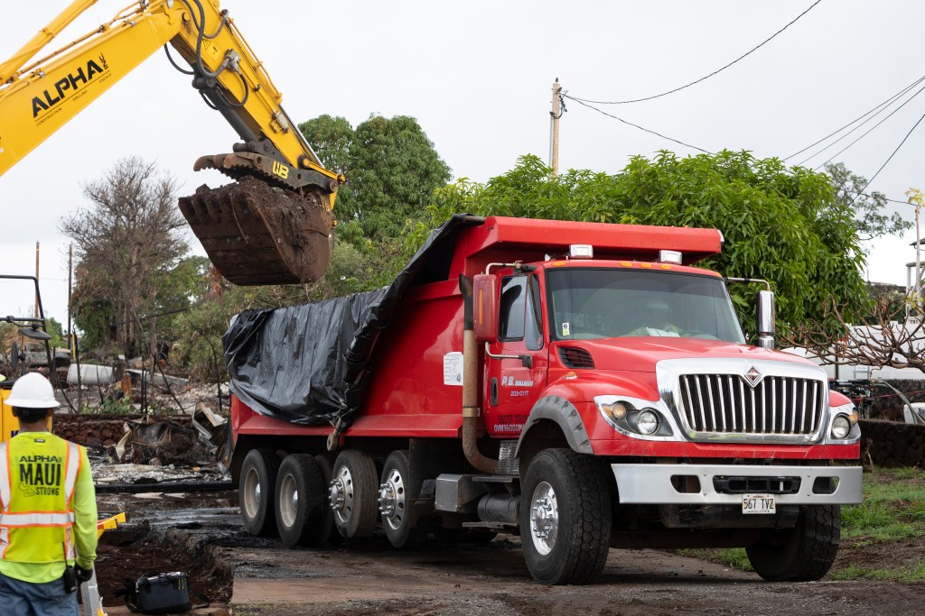 Alpha Inc. earthmover and P.B. Sullivan truck removing debris from Lahaina under contract with ECC Constructors and USACE in January 2024.