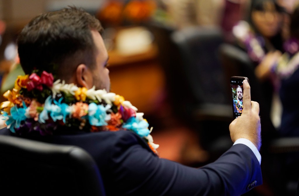 The House of Representatives majority whip Chris Todd makes a self portrait before the opening of the legislative session Wednesday, Jan. 17, 2024, in Honolulu. (Kevin Fujii/Civil Beat/2024)