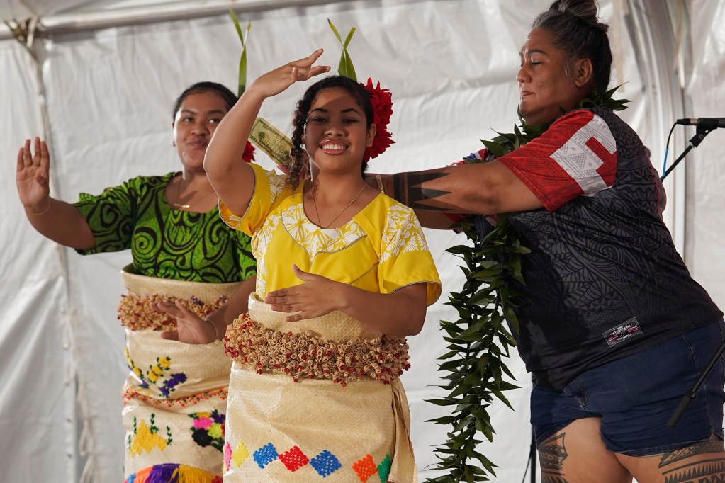 Tongan dancers perform while native Hawaiian cultural practitioner Hinaleimoana Wong-Kalu stuffs money into their shirts after the Hoʻūlu Lahaina Unity Walk Saturday, Jan. 20, 2024, in Lahaina. The unity event included cultural events of the people of Lahaina. (Kevin Fujii/Civil Beat/2024)