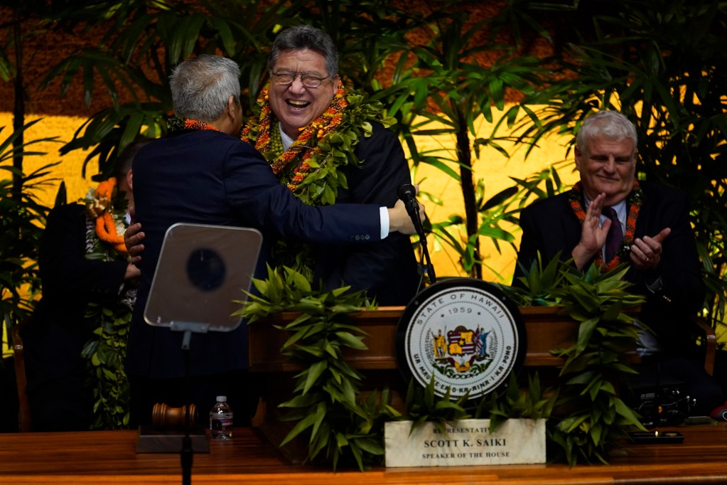House of Representative Speaker Scott Saiki gives Senate President Ron Kouchi a lei after Gov. Josh Green’s state of the state address Monday, Jan. 22, 2024, in Honolulu. Kouchi joked about not receiving a lei when introduced.  (Kevin Fujii/Civil Beat/2024)