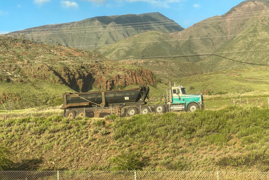 Photo of truck removing debris from fire-affected parts of Lahaina.