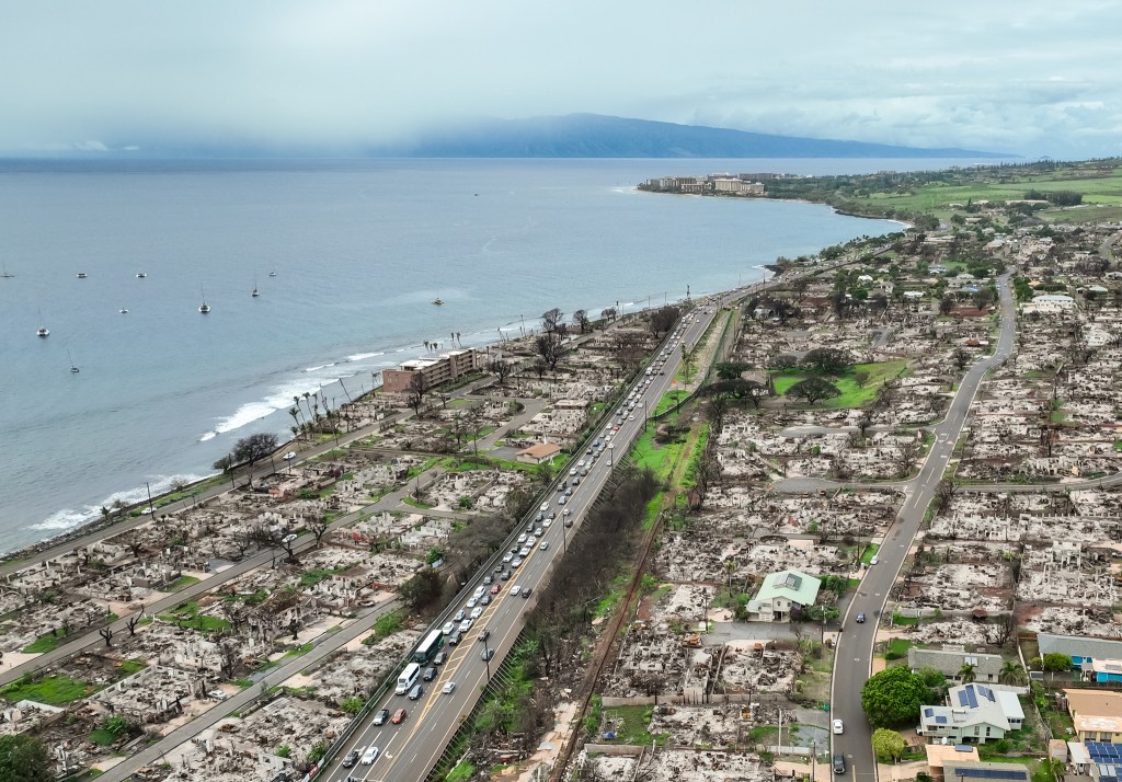 Traffic backs up going south through Lahaina on Thursday evening. The delays are due to the debris-removal work as crews clean up sites and truck it to the temporary landfill in Olowalu, Feb. 1, 2024. (Nathan Eagle/Civil Beat/2024)