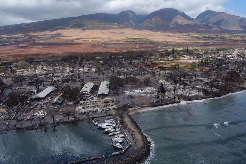 Malu Ulu O Lele Park sits in the upper right corner amid the destruction of Lahania town Thursday, Aug. 10, 2023, in Maui. The park sits on a former fishpond in the Mokuula area. A sheen of oil is also visible inside Lahaina Harbor. (Kevin Fujii/Civil Beat/2023)