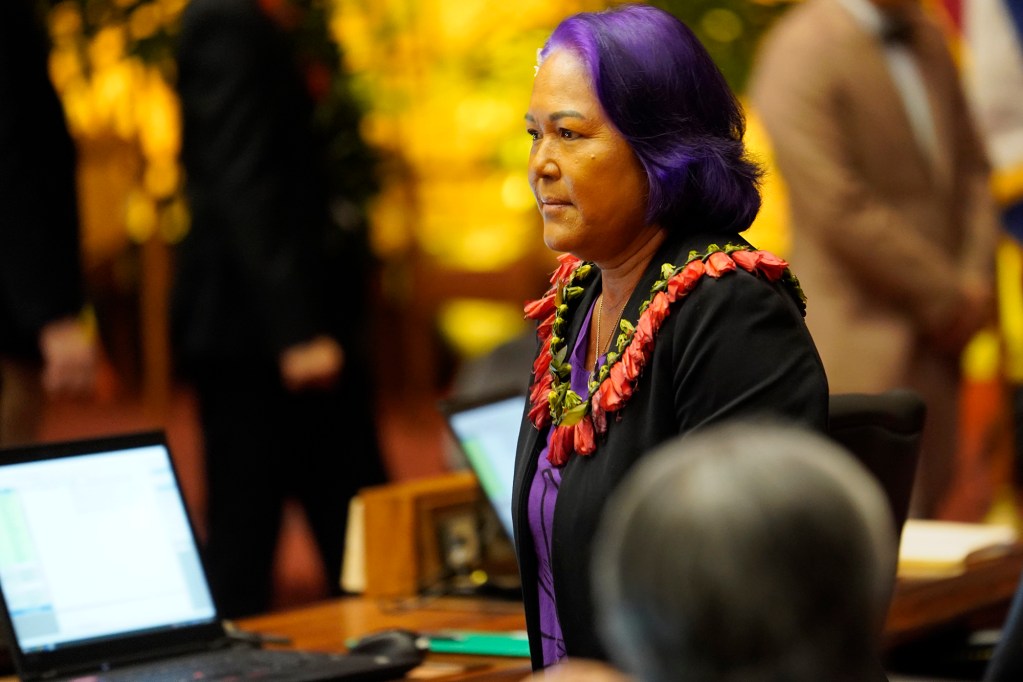 Rep. Elle Cochran walks the House of Representatives floor before passing the state budget HB1800 HD1 Wednesday, March 13, 2024, in Honolulu. The House of Representatives voted to pass its third reading to cross over to the senate. (Kevin Fujii/Civil Beat/2024)
