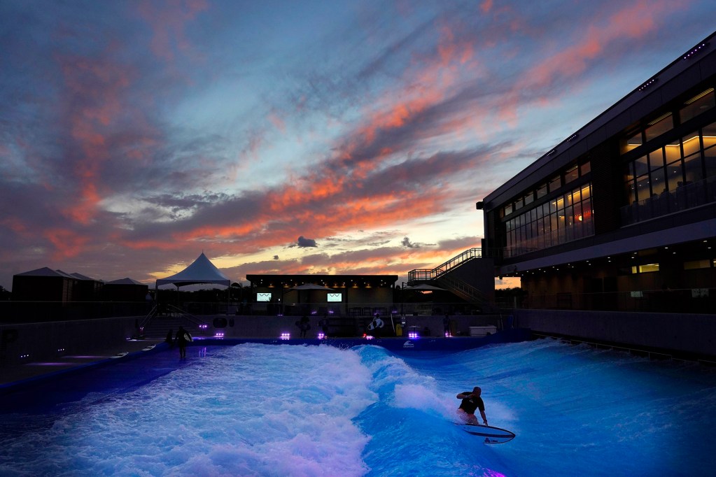 The sun sets on the first day of spring as a surfer rides the artificial wave at Wai Kai’s Lineup Tuesday, March 19, 2024, in Ewa Beach. (Kevin Fujii/Civil Beat/2024)