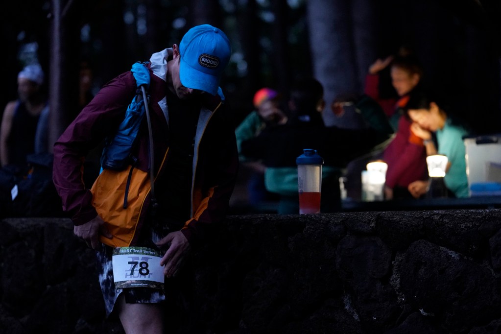 James Novak attaches his bib number before the Hawaiian Ultra Running Team, also known as HURT, kicks off their running season with the Aiea Loop Express at Keaīwa Heiau State Recreation Area Saturday, March 23, 2024, in Aiea. Runners consider this an easy course with a distance of only 6.75-mile and 1,442’ of elevation gain. The trail is mostly wide and free of challenging obstacles. (Kevin Fujii/Civil Beat/2024)