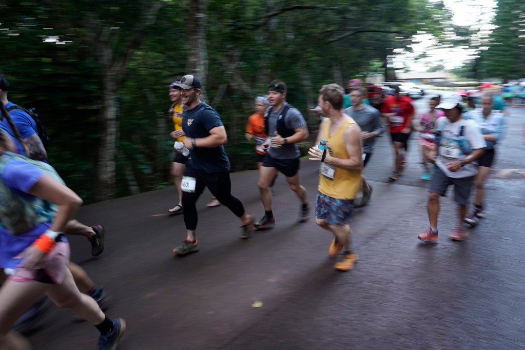 Hawaiian Ultra Running Team runners start off on pavement for the the Aiea Loop Express at Keaīwa Heiau State Recreation Area Saturday, March 23, 2024, in Aiea. Runners consider this an easy course with a distance of only 6.75-mile and 1,442’ of elevation gain. The trail is mostly wide and free of challenging obstacles. (Kevin Fujii/Civil Beat/2024)