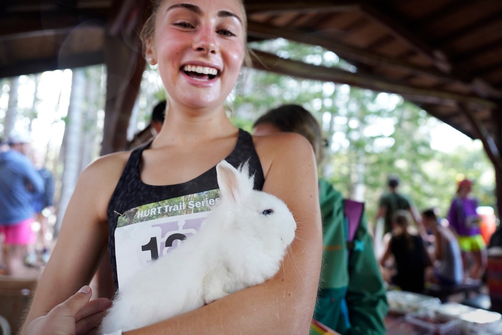 Hawaiian Ultra Running Team’s Aiea Loop Express women’s winner Arielle Zlotnick holds her good-luck charm, Coco, a four-month old lionhead rabbit, after her winning run at Keaīwa Heiau State Recreation Area Saturday, March 23, 2024, in Aiea. Zlotnick won the women’s division with a time of 57:41.6. She finished eighth overall. Runners consider this an easy course with a distance of only 6.75-mile and 1,442’ of elevation gain. The trail is mostly wide and free of challenging obstacles. (Kevin Fujii/Civil Beat/2024)