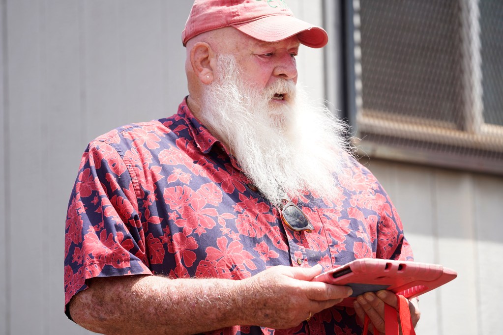 Ron Proctor signs off for his car off to be shipped to the mainland Monday, April 8, 2024, in Kahului. Proctor lived in Lahaina for 12 years. The Aug. 8 fire set things in motion for him to return to Napa, Calif., despite trying to stay in Maui. This past Christmas season was the most lucrative of his Santa Claus career. (Kevin Fujii/Civil Beat/2024)