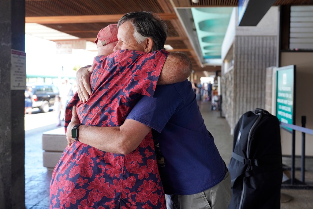 Will Cory of Pukalani hugs long-time friend Ron Proctor after dropping him off at the airport Tuesday, April 9, 2024, in Kahului. Proctor lived in Lahaina for 12 years. The Aug. 8 fire set things in motion for him to return to Napa, Calif., despite trying to stay in Maui. (Kevin Fujii/Civil Beat/2024)