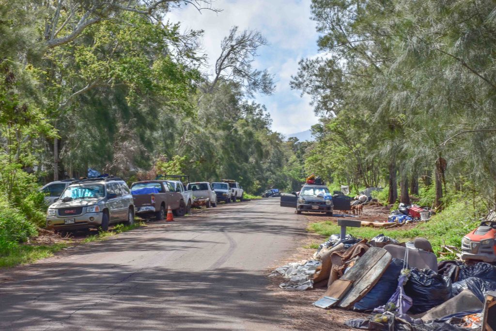 Maui police have been working with county departments to remove abandoned vehicles and dumped trash from Holomua Road on the North Shore of Maui. (Cammy Clark/Civil Beat/2024)