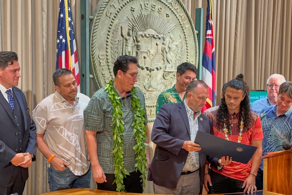 Governor Josh Green signed into law SB2919 on Friday May 3rd, 2024 which addresses the issue of illegal short-term rentals. SB 2919 aims to alleviate Hawaiʻi's housing crisis and increase housing levels throughout the state. This bill provides counties with home rule authority to see that vacation rentals are not allowed in communities that do not want them. It was instigated b y Lahaina Strong a grass roots movement headed by Paele Kiakona who spoke to those witnesses gathered to see the bill signed into law. (David Croxford/Civil Beat/2024)