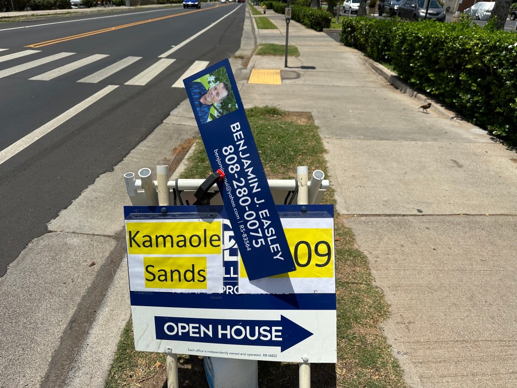 Photo of a realtor's signboard on South Kihei Road advertising a property sale at Kamaole Sands, a 440-unit development that is named in a Maui County inventory of short-term rentals.