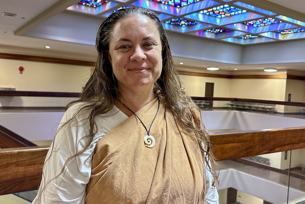 Ki'inaniokalani Kaho'ohanohano poses on Wednesday, June 12, 2024, in Honolulu. She is a Native Hawaiian cultural practitioner who is among those suing over a Hawaii law they say penalizes anyone who provides advice, information, or care, during pregnancy, birth, and postpartum who does not have a specific state license. (AP Photo/Jennifer Sinco Kelleher)