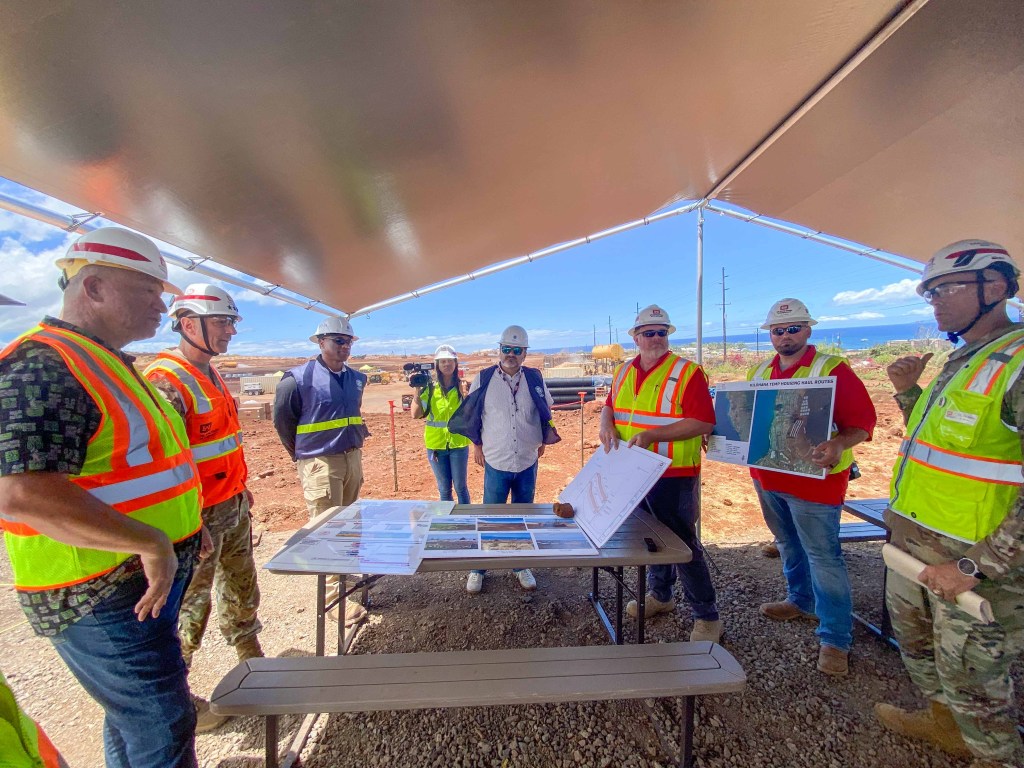 Maui Mayor Richard Bissen (far left) is with Army Corps of Engineers and FEMA officials to receive a briefing about the FEMA temporary housing site Kilohana for fire survivors that is in the background. (Cammy Clark/Civil Beat/2024)