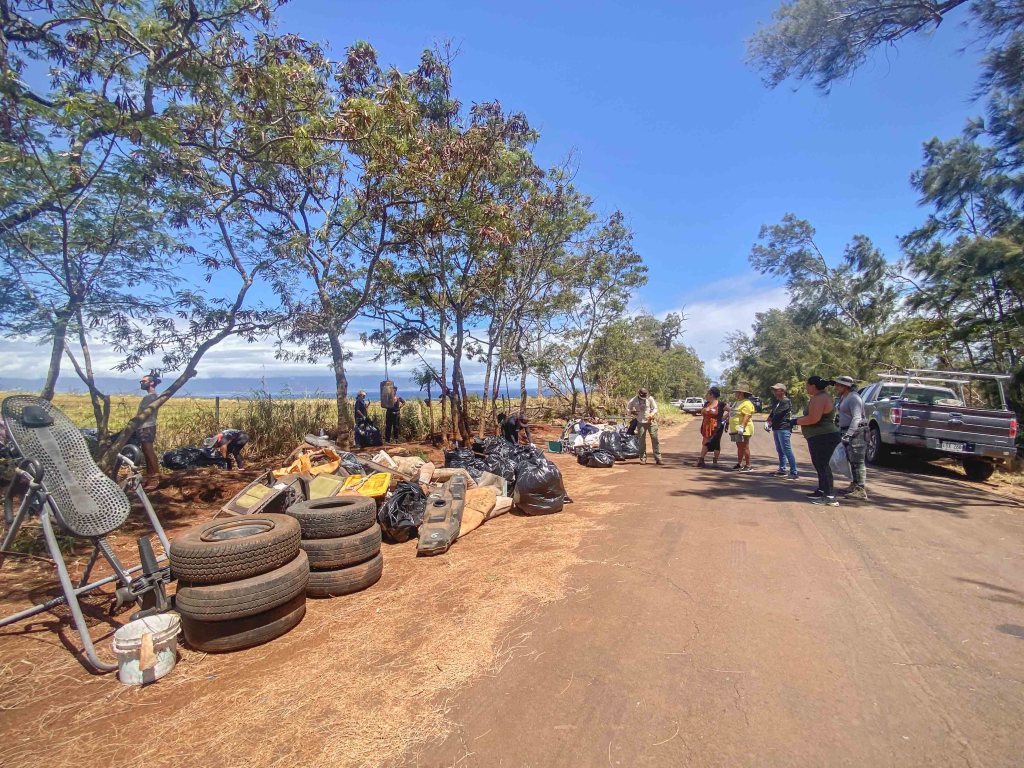 About 40 volunteers, including homeless people who live along Holomua Road, participated in a Father's Day cleanup. (Photo Courtesy: Mōʻī Kawaakoa)
