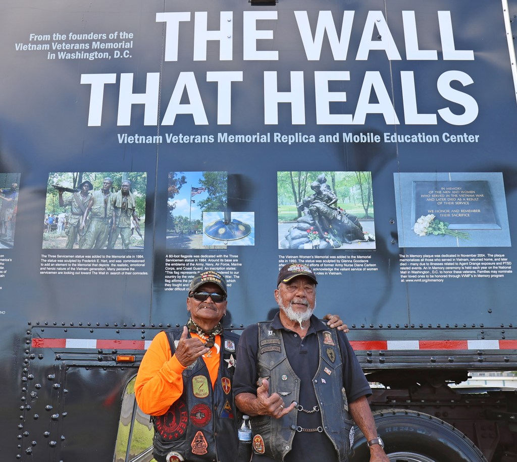 Anson Smith (right) and Melvin Tiogancco both Vietnam Veterans talk story next to "The Wall That Heals". Photo: Tim Wright