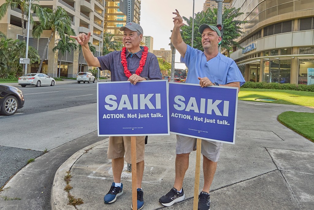 Hawaii Speaker of the House Scott Saiki was joined on Friday afternoon by Hawaii Gov. Josh Green at the corner of South Beretania and Alakea streets to sign wave during afternoon drive time. July 5th, 2024 (David Croxford/Civil Beat/2024)