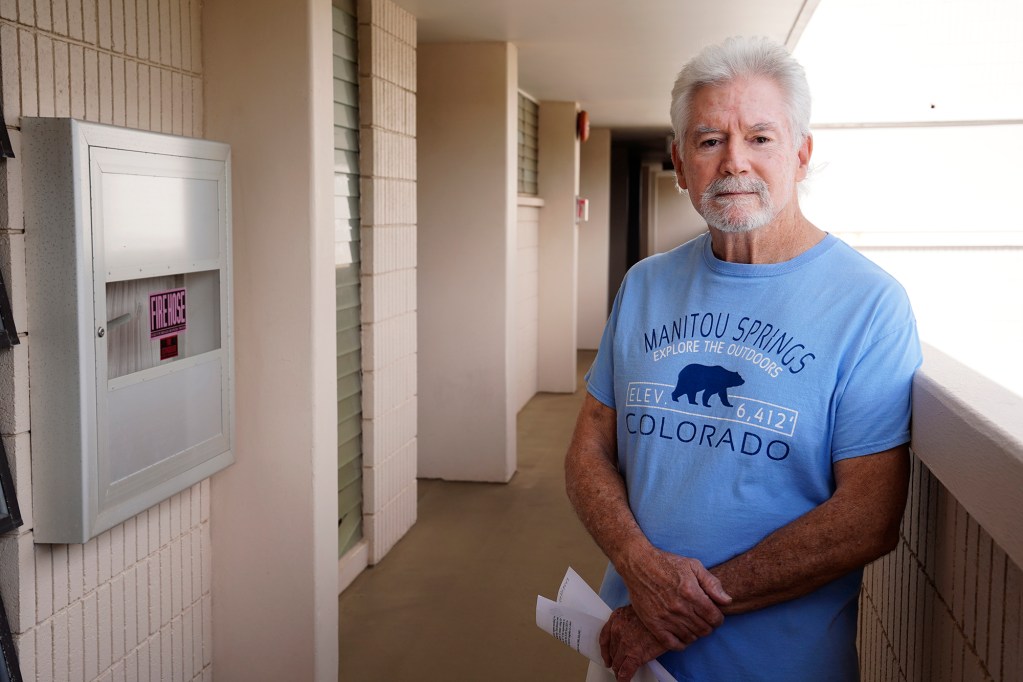 Kahala Towers resident Michael Howard poses for a photo Monday, July 29, 2024, in Honolulu. Howard claims the building is fireproof and offers other ways to mitigate fire hazards. He and other residents are being forced out of their condo units for up to a dozen days to remove asbestos to install fire sprinklers. (Kevin Fujii/Civil Beat/2024)