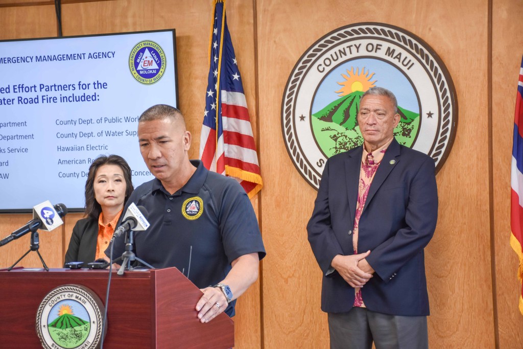 Maui Emergency Management Agency Administrator Amos Lonokailua-Hewett, flanked by Lt. Gov. Sylvia Luke and Maui Mayor Richard Bissen, provides an update July 15,2023, about the Crater Road Fire on the slope of Haleakala. (Cammy Clark/CIvil Beat/2024)