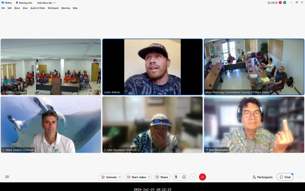 A screenshot from the Maui Planning Commission meeting Tuesday shows economist Paul Brewbaker giving the middle finger during testimony by Justin Kekiwi. (Maui Planning Commission/Screenshot/2024)