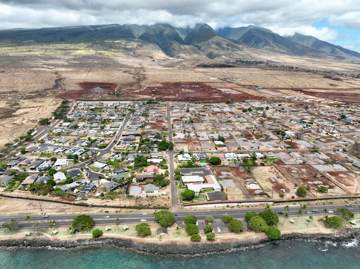 The state and federal government are building two adjacent temporary group housing projects mauka of the the Wahikuli neighborhood in north Lahaina. (Nathan Eagle/Civil Beat/2024)