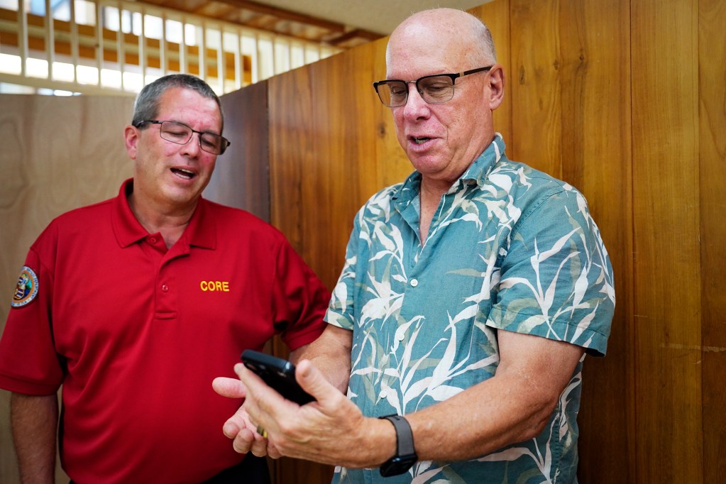 Honolulu Emergency Services Department Director Dr. Jim Ireland, left, excites Dr. Scott Miscovich about picking up a homeless patient in Kailua who’s been on their radar Monday, Aug. 19, 2024, in Honolulu. (Kevin Fujii/Civil Beat/2024)