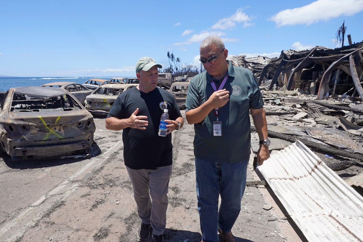Hawaii Gov. Josh Green, left, and Maui County Mayor Richard Bissen, Jr., speak during a tour of wildfire damage on Saturday, Aug. 12, 2023, in Lahaina, Hawaii. (AP Photo/Rick Bowmer)