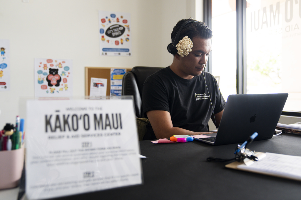 Kapili Akima works the front desk at the Kako’o Maui Resource Center on Monday, July 8, 2024, in Kahului, Hawaii. (AP Photo/Lindsey Wasson)