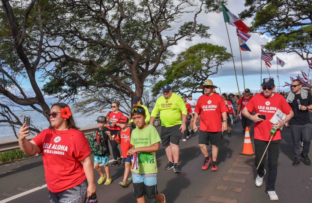 FEMA's Bob Fenton (yellow shirt) walks next to Maui Mayor Richard Bissen during the Hoʻūlu Lahaina Unity March that brought the community together for healing from the Aug. 8 wildfires. (Cammy Clark/Civil Beat/2024)