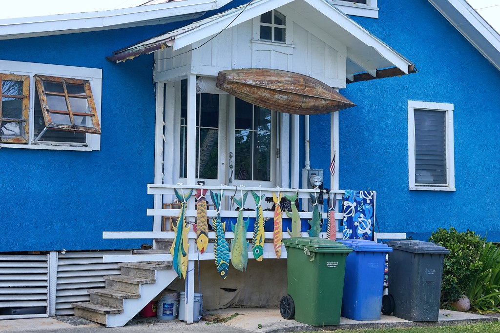 Ryan Wesley Routh, the man presently in Secret Service custody for attempting to assassinate former president Donald Trump, reportedly owed the property at 51-344 Kamehameha Highway (Blue building) in Kaaawa and worked at a property at 48-228 Kamehameha Hwy.
A truck sits on the driveway of the residence and has a flat rear tire and a Biden/Harris sticker on the tailgate.(David Croxford/Civil Beat/2024)